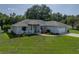 Attractive single-story home with a well-manicured lawn, lush landscaping, and a convenient two-car garage at 5427 Orange Valley Dr, Lakeland, FL 33813