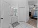 Hallway connecting the bathroom and main bedroom, featuring tile flooring and a vanity area at 5427 Orange Valley Dr, Lakeland, FL 33813