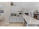 Open kitchen concept with bright white cabinetry, stainless steel appliances, and a view of the adjacent living area at 5427 Orange Valley Dr, Lakeland, FL 33813
