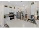 Lovely kitchen featuring white cabinetry, stainless steel appliances, and a view to the laundry room at 5427 Orange Valley Dr, Lakeland, FL 33813