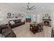 Comfortable living room featuring a fireplace, ceiling fan and a wall of framed photos at 5427 Orange Valley Dr, Lakeland, FL 33813