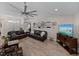 Open concept living room with neutral walls, ceiling fan, and an entertainment center at 5427 Orange Valley Dr, Lakeland, FL 33813