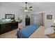 Well-lit main bedroom with dark wood furniture, ceiling fan, and a glimpse into the dining area at 5427 Orange Valley Dr, Lakeland, FL 33813