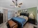 Spacious main bedroom with a ceiling fan, a green accent wall, and elegant furnishings at 5427 Orange Valley Dr, Lakeland, FL 33813