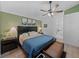 Cozy main bedroom featuring a decorative green wall, modern ceiling fan, and an ensuite bathroom at 5427 Orange Valley Dr, Lakeland, FL 33813