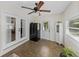 Sunroom featuring tile flooring, a ceiling fan, and access to the outdoors at 5427 Orange Valley Dr, Lakeland, FL 33813