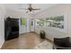 Sunroom featuring a black refrigerator, white cabinetry, and views of the outdoor greenery at 5427 Orange Valley Dr, Lakeland, FL 33813