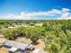 Aerial view of neighborhood near wooded area with blue sky and clouds at 603 Solana St, Lakeland, FL 33813