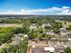 Aerial view of a neighborhood with houses and streets surrounded by lush trees at 603 Solana St, Lakeland, FL 33813