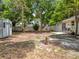 A view of an expansive back yard with mature shade trees, a storage shed, and a fenced in yard at 603 Solana St, Lakeland, FL 33813