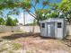 A backyard storage shed with a white fence on an expansive lot at 603 Solana St, Lakeland, FL 33813
