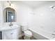 White bathroom features tub/shower combo, decorative lighting, and modern sink at 603 Solana St, Lakeland, FL 33813