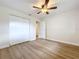 Bedroom with closet and adjacent doorway, featuring wood-look flooring at 603 Solana St, Lakeland, FL 33813