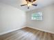 Bright and empty bedroom with hardwood-style floors, window, and ceiling fan at 603 Solana St, Lakeland, FL 33813