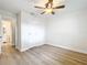 Bedroom with wood floors offers a nearby bathroom for convenience at 603 Solana St, Lakeland, FL 33813