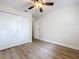 Bedroom featuring a ceiling fan, closet, and wood-look flooring at 603 Solana St, Lakeland, FL 33813