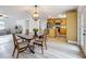 Dining room with chandelier open to kitchen and living room with wood-look floors at 603 Solana St, Lakeland, FL 33813