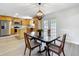Bright dining room open to the kitchen with a stylish chandelier and view of backyard through french doors at 603 Solana St, Lakeland, FL 33813