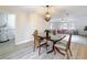 Dining room open to living room and adjacent to laundry room, featuring modern light fixture at 603 Solana St, Lakeland, FL 33813