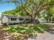 Picture of a lovely single Gathering home with a brick exterior with shade trees and a green lawn at 603 Solana St, Lakeland, FL 33813