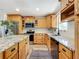 Beautiful kitchen featuring granite countertops, stainless steel appliances, wood cabinets, and modern fixtures at 603 Solana St, Lakeland, FL 33813