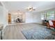 Open-concept living room showcasing hardwood floors and easy access to dining area, great for entertaining at 603 Solana St, Lakeland, FL 33813