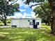 Backyard of a home with lush green grass and mature trees offering plenty of shade at 6611 Glen Meadow Loop, Lakeland, FL 33810