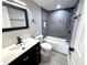 Modern bathroom featuring gray tile, sleek black fixtures, and a shower-over-tub design at 6611 Glen Meadow Loop, Lakeland, FL 33810