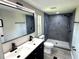 Renovated bathroom featuring double sinks, a large mirror, and a tiled walk-in shower at 6611 Glen Meadow Loop, Lakeland, FL 33810