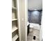 Bathroom with black hardware, gray tile tub-shower and a closet with storage shelving at 6611 Glen Meadow Loop, Lakeland, FL 33810