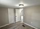 Bedroom with laminate flooring, neutral paint, and closets with white doors at 6611 Glen Meadow Loop, Lakeland, FL 33810