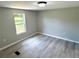 Bedroom with laminate floors, a view of outside from the window, and neutral walls at 6611 Glen Meadow Loop, Lakeland, FL 33810