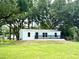 Single-story home featuring a well-maintained lawn and mature trees at 6611 Glen Meadow Loop, Lakeland, FL 33810