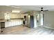 Open kitchen featuring stainless steel appliances and luxury vinyl plank flooring at 6611 Glen Meadow Loop, Lakeland, FL 33810