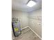 Clean laundry room featuring a new water heater, new LVP flooring and utility hookups at 6611 Glen Meadow Loop, Lakeland, FL 33810