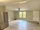 Open-concept living room with luxury vinyl plank flooring adjacent to kitchen at 6611 Glen Meadow Loop, Lakeland, FL 33810