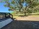 Backyard featuring a mature tree and a wood deck area at 7005 Dove Meadow Trl, Lakeland, FL 33810