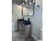 Bathroom vanity features dual sinks, a modern mirror, and wood-look cabinetry at 7005 Dove Meadow Trl, Lakeland, FL 33810