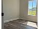 A quaint bedroom is naturally lit with a large window and features wood-look flooring at 7005 Dove Meadow Trl, Lakeland, FL 33810