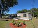 Charming gray home with a manicured lawn, updated windows, and a welcoming front porch at 7005 Dove Meadow Trl, Lakeland, FL 33810
