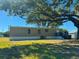 Exterior view of home showcasing its large backyard and wood deck at 7005 Dove Meadow Trl, Lakeland, FL 33810