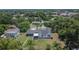 A high aerial perspective displays the home's position among a canopy of trees within the neighborhood at 733 S Clayton Ave, Lakeland, FL 33801