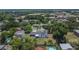 Aerial view of the home with lush green surroundings and a glimpse of the distant cityscape at 733 S Clayton Ave, Lakeland, FL 33801