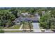 An aerial view of a quaint neighborhood showcases a charming home and its proximity to lush greenery at 733 S Clayton Ave, Lakeland, FL 33801
