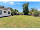 View of the backyard and lawn, showcasing the home's proximity to nature at 733 S Clayton Ave, Lakeland, FL 33801
