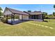View of backyard and screened in porch at 733 S Clayton Ave, Lakeland, FL 33801