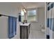 Bathroom with a dark vanity, white countertops, stylish mirror and modern fixtures at 733 S Clayton Ave, Lakeland, FL 33801