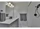 Contemporary bathroom features a marble countertop, modern fixtures, subway tile shower, and black shower head at 733 S Clayton Ave, Lakeland, FL 33801