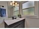 This bathroom features a dark wood vanity, white countertop and frosted window at 733 S Clayton Ave, Lakeland, FL 33801