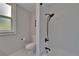 Modern bathroom with white subway tiles in the shower, updated fixtures, and a toilet at 733 S Clayton Ave, Lakeland, FL 33801